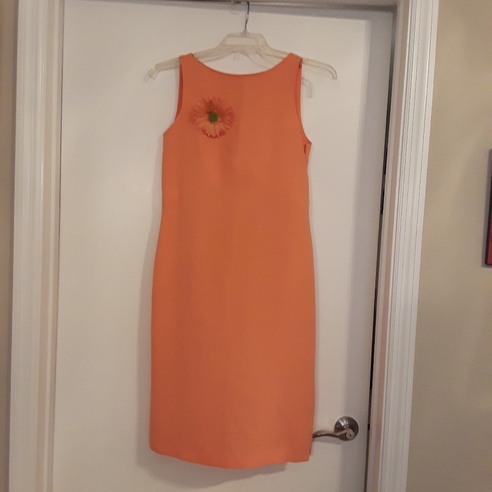J. Michael's tangerine dress with flower pin